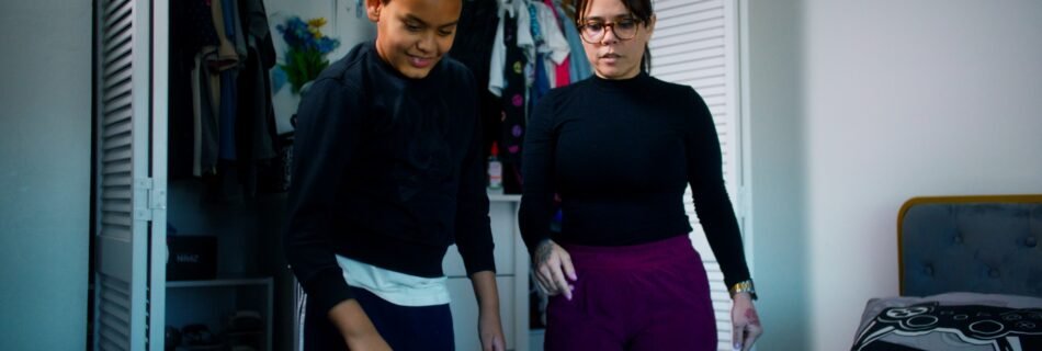 ChatGPT Plus Child with autism organizing clothes at home with their mother, using ABA strategies with professional support from Open Door Behavioral Services.
