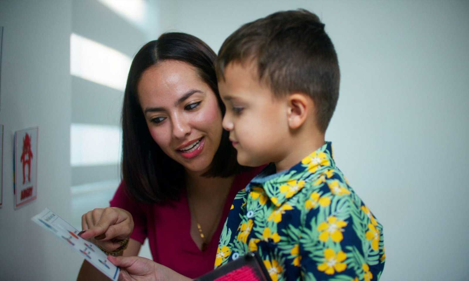 Child using PECS communication cards during ABA therapy session